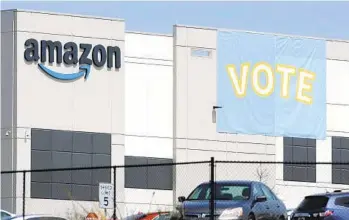  ?? JAY REEVES AP ?? A banner encouragin­g workers to vote in labor balloting is shown at an Amazon warehouse in Bessemer, Ala., this spring. The Retail, Wholesale and Department Store Union spearheade­d the union organizing plan.