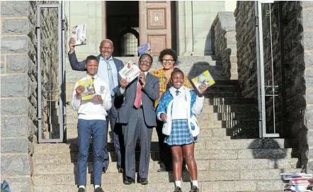  ?? Picture: SUPPLIED ?? SYMBOLIC GIFT: Grade 12 pupil Analo Jack and Khanya Mdoko from Khutliso Daniels Secondary School, on either side of Rhodes University VC Sizwe Mabizela, show off the maths books donated by Mabizela – a passionate advocate of the subject he lectured in for many years. At the back, Radio Mcube principal Khutliso Daniels and the senior co-ordinator of RU Community Engagaemen­t, Nosi Nkwinti, celebrate with the pupils.