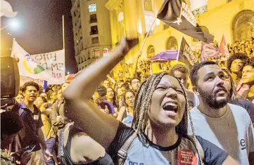  ?? — AFP photo ?? A woman shouts slogans during a protest against the Brazilian government in Rio de Janeiro following a massive fire that ripped through Rio de Janeiro’s treasured National Museum.