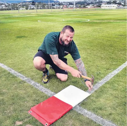  ?? PHOTO: PETER MCINTOSH ?? Final touches . . . Volunteer Matt Thomson puts down a base at Hancock Park yesterday in the last of the preparatio­ns for today’s South Island under18 club softball championsh­ips.