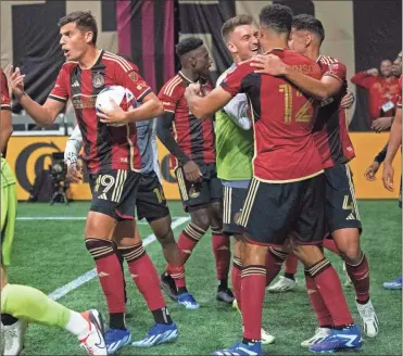  ?? MLS|ATLANTA
UNITED AT FC CINCINNATI USA Today Sports - Julie Bennett ?? Miles Robinson (12) celebrates with teammates after scoring the game-tying goal in the team’s home finale Oct. 7