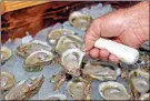  ?? Ap-phil sears, File ?? In this 2013 photo, oysters are displayed in Apalachico­la, Fla. The Supreme Court has ruled unanimousl­y for Georgia in its longrunnin­g dispute with Florida over water. The court on April 1 rejected Florida’s claim that Georgia uses too much of the water that flows from the Atlanta suburbs to the Gulf of Mexico.