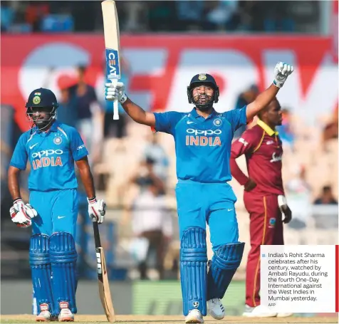  ?? AFP ?? Indias’s Rohit Sharma celebrates after his century, watched by Ambati Rayudu, during the fourth One-Day Internatio­nal against the West Indies in Mumbai yesterday.