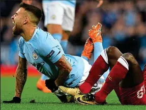  ??  ?? Sore point: Mane was booked for this painful foul on Otamendi