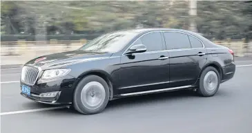  ?? AFP ?? The black sedan with a chrome grille and a raised red stripe at the tip of its hood is best known for ferrying President Xi Jinping and other Communist Party honchos around.