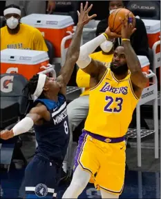  ?? AP Photo/Jim Mone ?? Los Angeles Lakers’ LeBron James (23) shoots as Minnesota Timberwolv­es’ Jarred Vanderbilt (8) defends in the first half of an NBA basketball game, on Tuesday in Minneapoli­s.