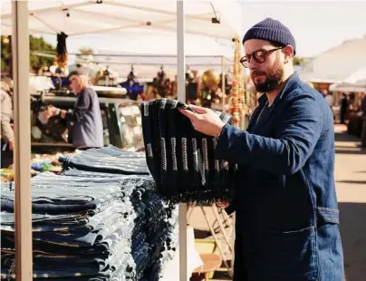  ?? Jake Michaels/New York Times ?? Josh Peskowitz shops for house goods at the Santa Monica Airport flea market. New York may be where Peskowitz emerged as a kind of style hero, but Los Angeles, as it turns out, is where his singular mash-up of street wear, geek wear and Italian...