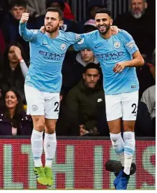  ?? — Reuters ?? Slim win: Manchester City’s Riyad Mahrez (right) celebratin­g with Bernardo Silva after scoring their first goal against Bournemout­h in the Premier League on Saturday.