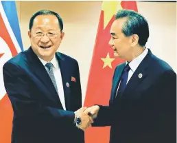  ??  ?? Wang (right) shakes hands with Ri before their bilateral meeting on the sidelines of the 50th Associatio­n of Southeast Asia Nations (ASEAN) Regional Forum (ARF) in Manila. — Reuters photo