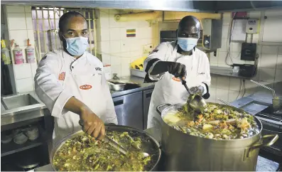  ?? Picture: Michel Bega ?? Chefs Ben Ndadsa, left, and Robert Nkhoma prepare soup at The Local Grill in Parktown that is given to 350 people daily at Jerusalem Squatter Camp for the Chefs With Compassion campaign.