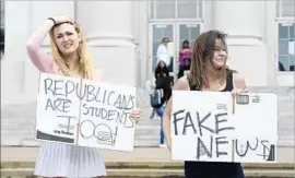  ?? Dan Honda East Bay Times ?? UC BERKELEY students Ashton Whitty, left, and Hailey Carlson protest during a College Republican­s news conference about Ann Coulter’s canceled appearance.