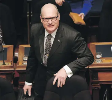  ??  ?? Finance Minister Mike de Jong arrives to deliver his budget speech to the legislatur­e on Tuesday. The budget included a 50 per cent reduction in Medical Services Plan premiums.