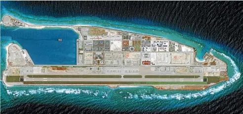  ?? GETTY ?? A 2018 DigitalGlo­be overview imagery of the Fiery Cross Reef, in the western part of the Spratly islands group in the South China Sea. It has undergone large-scale reclamatio­n by China.