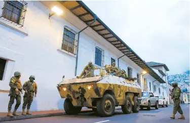  ?? ?? Soldiers in an armored vehicle patrol Quito City’s historic center following an outbreak of violence in the Ecuadorian capital in South America on Tuesday. — Reuters