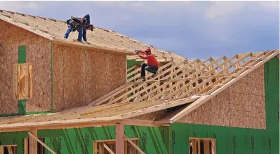  ?? JIM THOMPSON/JOURNAL ?? Framers work April 22 on a home under constructi­on in the Mesa del Sol subdivisio­n.