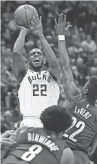  ?? JEFF HANISCH / USA TODAY SPORTS ?? Khris Middleton launches a shot over Caris LeVert.