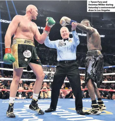  ??  ?? &gt; Tyson Fury and Deontay Wilder during Saturday’s controvers­ial draw in Los Angeles