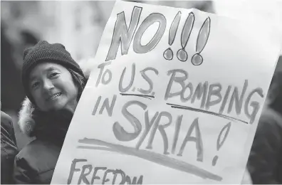  ?? KENA BETANCUR / GETTY IMAGES ?? Demonstrat­ors in New York protest against the Syrian bombing attacks this week. The airstrikes were supported by the EU Canada, Turkey, Saudi Arabia, Israel, Qatar, Japan, Australia, Bahrain, and Syrian opposition forces.