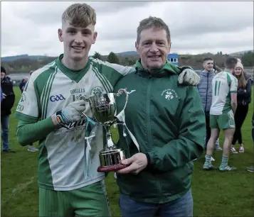  ??  ?? A proud Robert McHugh with his son and Baltinglas­s full-forward Adam McHugh after the victory over AGB in the Under-20 ‘A’ Football Championsh­ip final in Joule Park Aughrim.