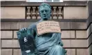  ??  ?? A sign hangs from the statue of the 18thcentur­y philosophe­r David Hume in Edinburgh after a Black Lives Matter protest in June. Photograph: Jane Barlow/PA