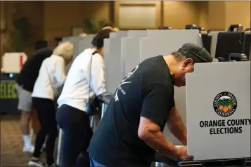  ?? LAUREN JUSTICE — FOR CALMATTERS ?? Voters fill out their ballots at a vote center at the Huntington Beach Central Library in Huntington Beach on March 5, 2024.