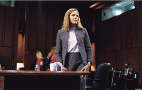  ?? Stefani Reynolds / Associated Press ?? Supreme Court nominee Amy Coney Barrett departs during a break in a confirmati­on hearing before the Senate Judiciary Committee in Washington on Wednesday.