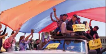  ?? NAREK ALEKSANYAN, PAN PHOTO VIA AP ?? Protesters hold a huge Armenian national flag as they gather in Republic Square in Yerevan, Armenia, Wednesday. Several thousand protesters took to the streets of the Armenian capital on Wednesday morning after talks between the opposition and the...