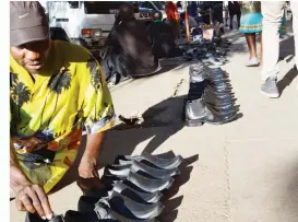  ??  ?? A shoemaker, Mr Tabanda Gumbo arranges new men’s shoes that he manufactur­es for sale on a pavement along Leopold Takawira Avenue in Bulawayo in this file photo. Mr Gumbo is self employed