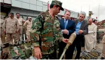  ?? PHOTO: REUTERS ?? A rebel fighter shows British Defence Secretary Liam Fox weapons abandoned by Muammar Gaddafi’s forces in Misrata in October 2011. A new report says failure to secure these weapons ‘‘increased terrorism’’ in north Africa.