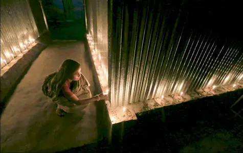  ?? Associated Press photos ?? A woman lights candles Friday in celebratio­n at Dashiarchh­ara, in Kurigram enclaves, Bangladesh.