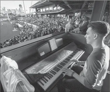  ?? Arkansas Democrat-Gazette/MITCHELL PE MASILUN ?? Arkansas Travelers organist Trey Trimble of Cabot is in his ninth season performing for the team at Dickey-Stephens Park in North Little Rock.