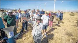  ?? Allen J. Schaben Los Angeles Times ?? SEISMOLOGI­ST Lucy Jones, holding a microphone, helps lead about 50 policymake­rs and others on a recent tour of the San Andreas fault in Palm Springs.