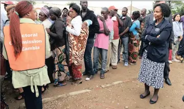 ??  ?? TIME TO CHOOSE: Zambians wait to cast their votes at a polling station in Lusaka in this file picture. The majority in the nation have voted in favour of remaining with the ICC.