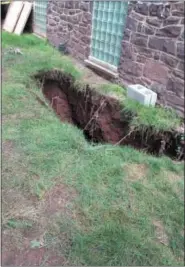  ??  ?? This sinkhole appeared at a stormwater arch behind 1200 E. High St. in August.