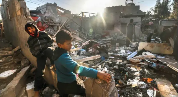  ?? AFP ?? Palestinia­ns look for things to salvage from the rubble of a building destroyed in an Israeli bombardmen­t in Rafah, southern Gaza, on Thursday