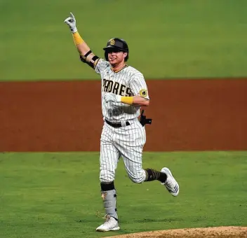  ?? Gregory Bull / Associated Press ?? Jake Cronenwort­h had a walk-off single in the 10th inning Friday, preserving the Padres’ win on a day in which they made MLB history with a fourth grand slam in as many days.