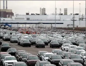  ?? (AP) ?? Jeep vehicles are parked outside the Jefferson North Assembly Plant in Detroit in this file photo. Major U.S. automakers are planning to reopen North American factories this month.