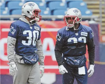  ?? STAFF PHOTO BY JOHN WILCOX ?? TACKLING TOUGH SUBJECT: Devin McCourty (right) chats with fellow Patriots defensive back Duron Harmon before practice yesterday at Gillette Stadium.