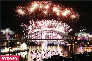  ??  ?? SYDNEY
Light fantastic: The firework display in the sky above Sydney Harbour Bridge