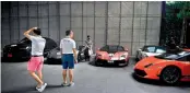  ?? AFP ?? This photo shows Lamborghin­i owners looking at a row of supercars at a Lamborghin­i Club Thailand event at a showroom in Bangkok. —