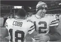  ?? CHARLES REX ARBOGAST/ THE ASSOCIATED PRESS ?? Green Bay Packers quarterbac­k Aaron Rodgers, right, celebrates wide receiver Randall Cobb’s game-winning touchdown reception against the Chicago Bears to capture the NFC North title on Dec. 29.