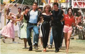  ??  ?? Film finale: Sandy and Danny lead the cast of Grease in We Go Together, filmed at the John Marshall High School in Los Angeles