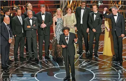  ?? MIKE BLAKE / REUTERS ?? Director Alejandro Inarritu accepts the Oscar for best picture for his film Birdman during the 87th Academy Awards in Los Angeles, California, on Sunday with members of the cast and others.