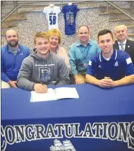  ?? Photo by Ernest A. Brown ?? Cumberland senior Andre Bibeault (front left), signed a National Letter of Intent to play football at URI. Bibeault was joined at his signing ceremony by (clockwise from top left) Cumberland AD Matt Campanelli, Carol Bibeault, guidance counselor James...