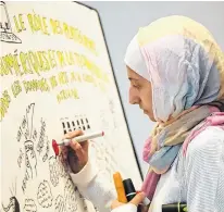  ?? JEAN LEVAC • POSTMEDIA NEWS ?? Assma Basalamah works on a graphic story board during the National Culture Summit held at the National Arts Centre in Ottawa on May 4.