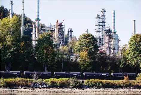  ?? DARRYL DYCK/BLOOMBERG FILES ?? A CP Rail locomotive pulls oil tankers past a refinery in Burnaby, B.C. Royal Bank analyst Greg Pardy argues that Alberta has the power on its own to improve crude oil prices by draining storage instead of turning to the traditiona­l solution of rail exports.