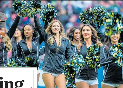  ?? Pictures: TIM WILLIAMS & JOE ROBBINS/Getty ?? TOUCH DOWN: Quarterbac­k, and above, cheerleade­rs perform at Wembley