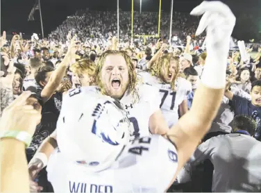  ?? Michael Shroyer / Getty Images ?? Old Dominion offensive lineman Nick Clarke leads the celebratio­n after a victory over Virginia Tech.