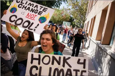  ?? DAI SUGANO — STAFF PHOTOGRAPH­ER ?? Los Altos High School students including Izzi Boustead, center, and Montserrat Mendez, left, chant during a march demanding action on climate change Friday in Mountain View. About 50students walked out of the school to join the demonstrat­ion.