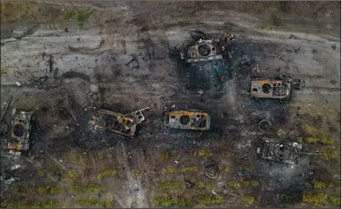  ?? (AP/Rodrigo Abd) ?? Destroyed Russian armored vehicles sit on the outskirts of Kyiv, Ukraine, on Thursday. As Russian forces appeared to be withdrawin­g from parts of Ukraine, in the east, military leaders said they were preparing for an all-out Russian assault.